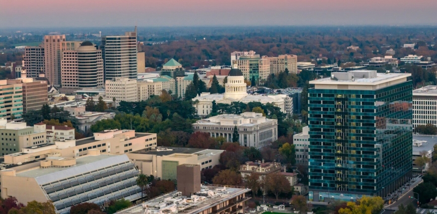 City skyline with capitol building at sunset